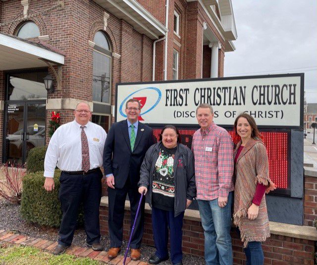 Representing Spoon River College: Brad O’Brien, Dean of Career & Workforce Education, and Dr. Curt Oldfield, President; and representing First Christian Church (Disciples of Christ) of Macomb: Patti Jones, Rev. Kelly Ingersoll, and Anne Ingersoll in front of FCC sign.