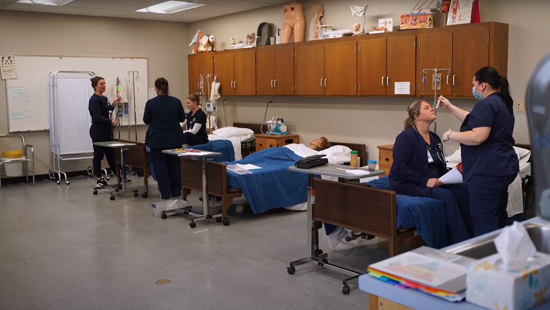 Nursing and healthcare students working together in patient lab