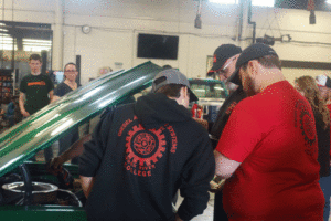 Students looking at a '66 Chevelle SS at 2022 Tractor & Car Cruise-In