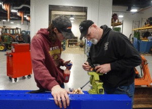 Diesel and Power Systems Technology student and instructor working on a project in the shop 