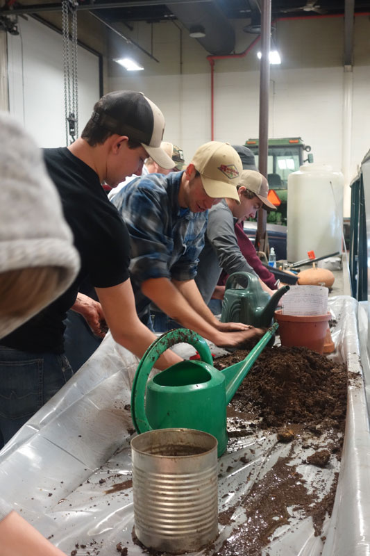 Students working in a plant potting area