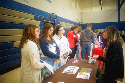 prospective students at booth during college and transfer fair