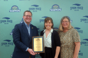 President Oldfield presenting teaching awards to Beth Van Tine and Shelli Stuart