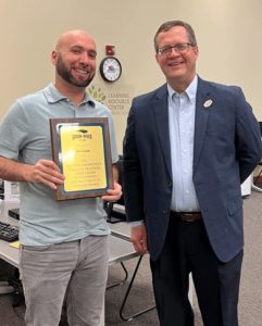 President Oldfield presenting teaching award to Joe Glenn