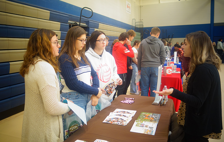 students speaking with a college representative