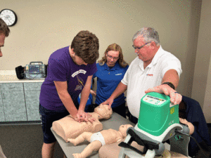 students performing CPR on manikins during 10th Grade Career Expo