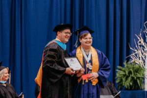 Image of Delaney Eastwood receiving a Student Achievement Award from President Oldfield at the 63rd Commencement at Spoon River College