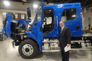 President of Spoon River College Dr. Curt Oldfield stands by a new semi-tractor that was part of a $1.5M EDA grant.