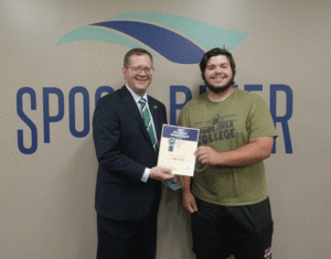 President Oldfield presents student Ryne Crum with a $100 Visa gift card for being named a Student Shout-Out Award recipient.