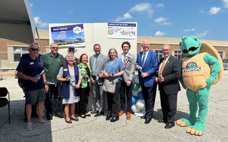 Group of dignitaries holding hammers for the "wall breaking" ceremony, including SRC president, Curt Oldfield, several elected officials, business people, and SRC board members, as well as SRC Snappers mascot, Sheldon