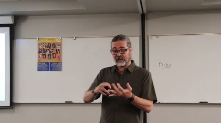Sociology professor, Micheal Maher giving the college theme presentation, "Embrace the Change that Becomes You"