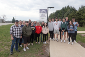 Members of SEA as well as students who live in the Snapper Villas on the Canton Campus are pictured by the sign on the pathway between the Multi-Purpose Building and the Snapper Villas housing unit where solar lighting was installed thanks to a grant from IGEN.