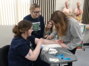 image of nursing students learning to do IV insertions