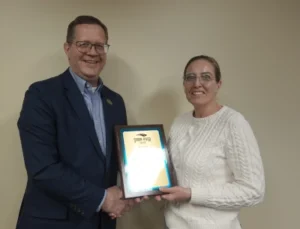 Image of Faculty Award recipient Sarah Etter being presented her award by President Oldfield