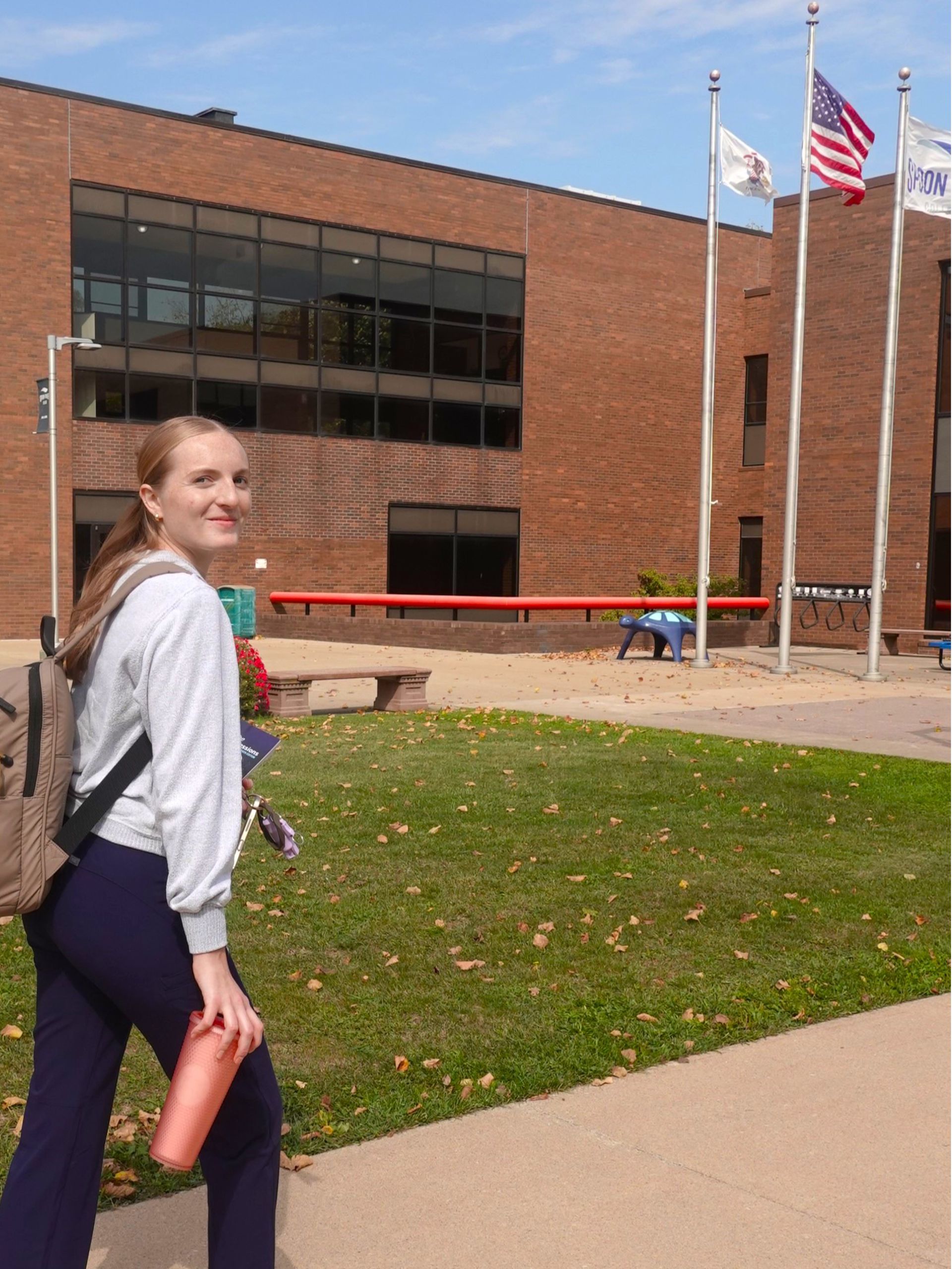 Female student with backpack outside the SRC Canton campus buildings.