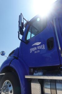 Close up of blue truck cab with the SRC logo on the driver's door